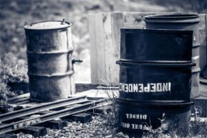Black and white photo of combustible waste stored in containers at a mining site, following MSHA safety guidelines.